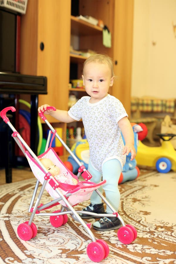 Baby playing with doll