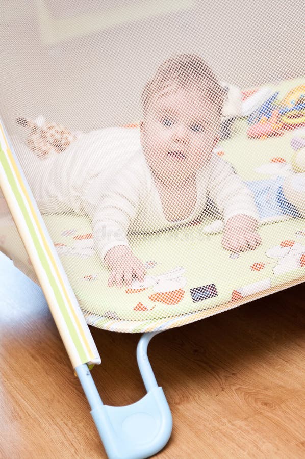 Baby girl in playpen stock image. Image of cute, play 16349131