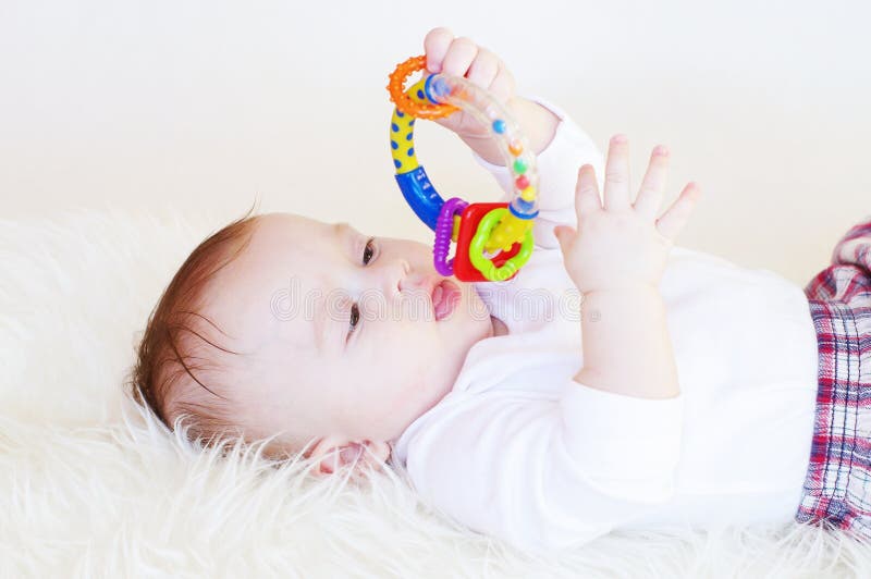 Baby with a rattle stock image. Image of large, beautiful 34329519