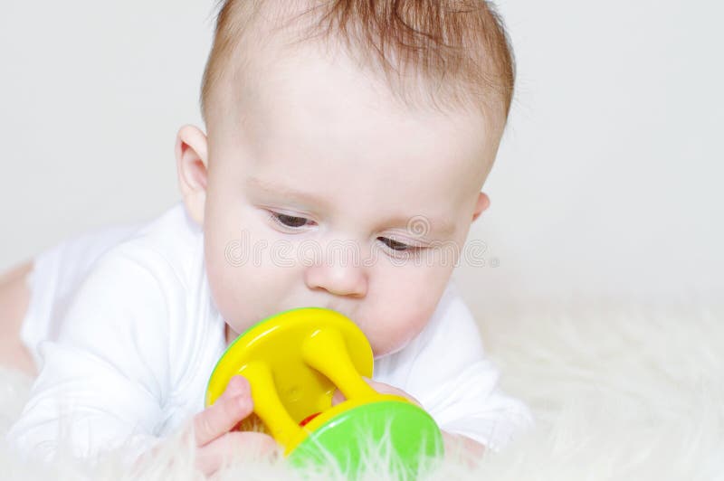 Baby with a rattle stock photo. Image of largely, dream 34329568