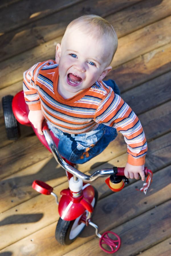 Baby riding tricycle stock image. Image of adorable, active 5359941