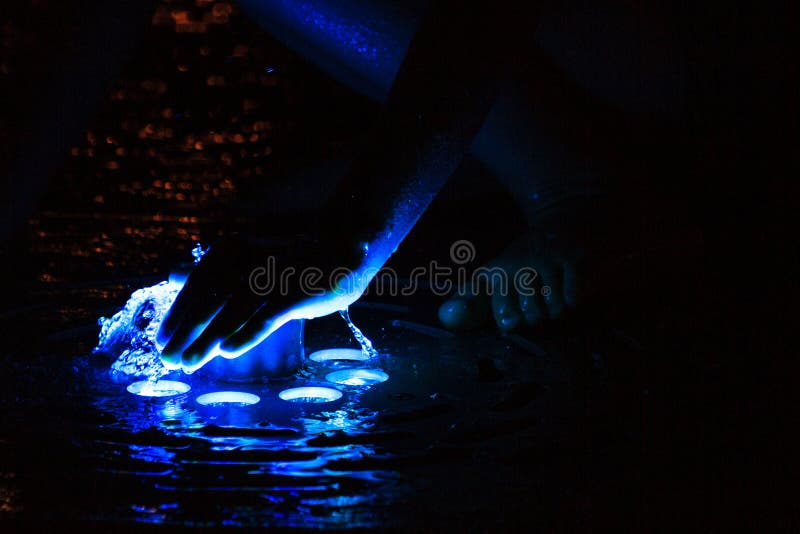 Baby`s Hand in the Dark Covers the Colored Water Stock Image Image of