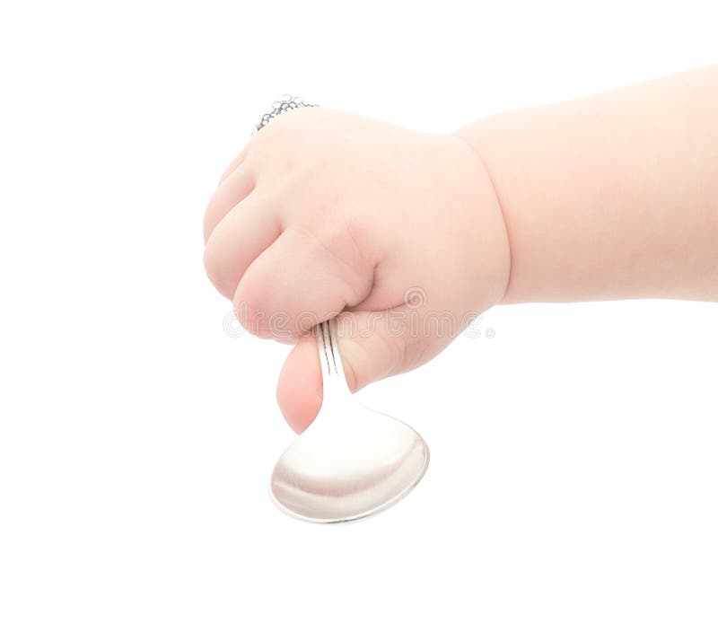 Baby's hand holding a silver spoon, isolated over white. Baby's hand holding a silver spoon, isolated over white