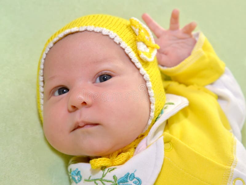 The Baby S Portrait in a Yellow Cap on a Green Background Stock Photo Image of monthly, green