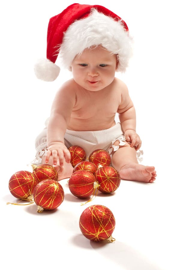 Baby in Santa hat playing