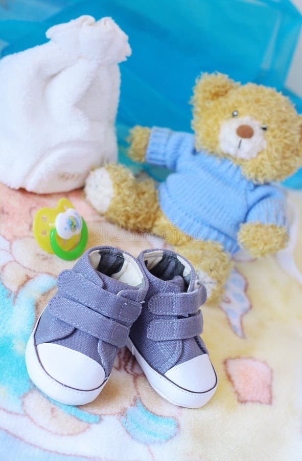 Baby shoes and teddy bear in blue