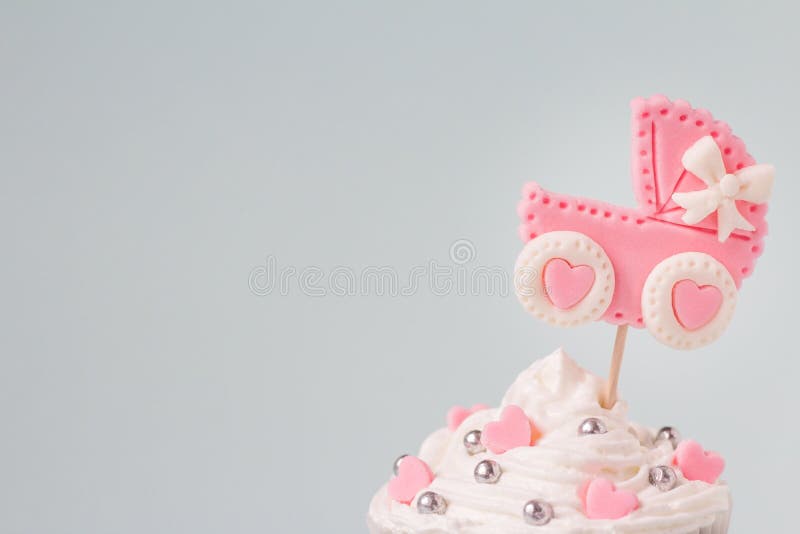 Baby shower cupcake for a girl, close up. Newborn announcement concept. Text space