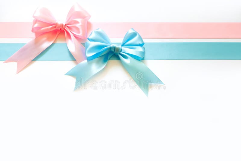 Blue and pink wide satin ribbon with a bow. White background. Birth of a boy or girl