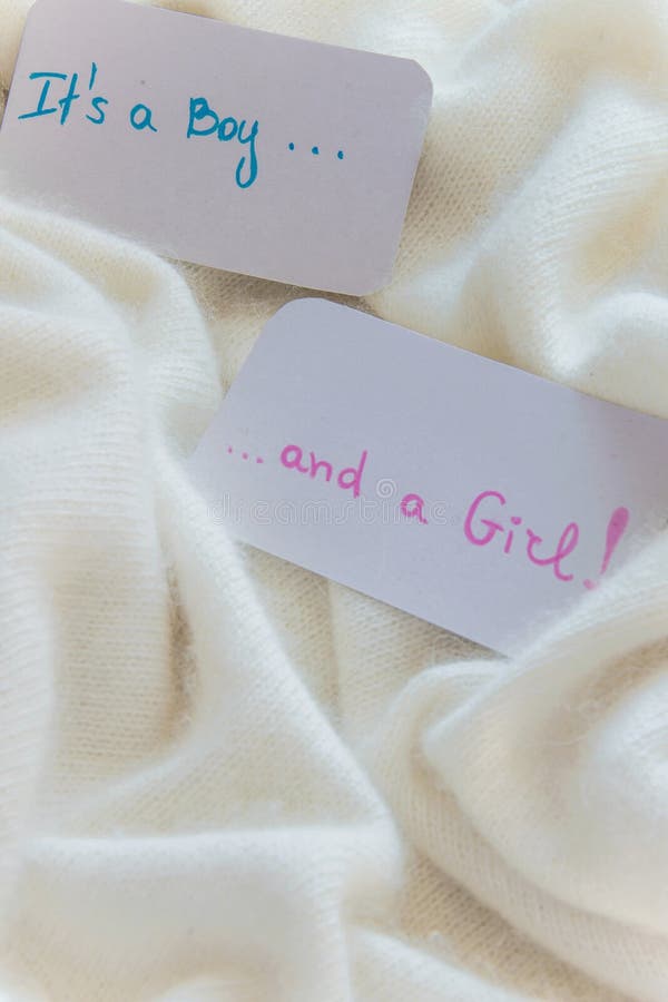 Baby shower `It`s a boy...and a girl`, announcement card on cozy warm white blanket with space for text. Twins arrivals stock photo Baby shower `It`s a boy...and a girl`, announcement card on cozy warm white blanket with space for text. Twins arrivals stock photo