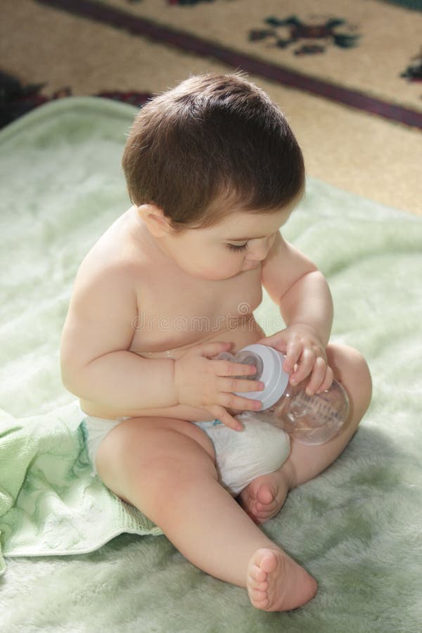 Baby with bottle stock photo. Image of infant, laying 14903910