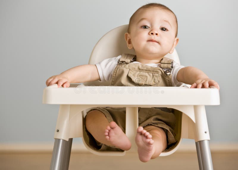 Baby sitting in highchair