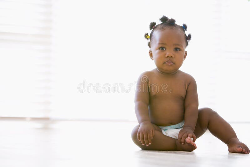Baby sitting indoors Royalty-Free Stock Image - Storyblocks