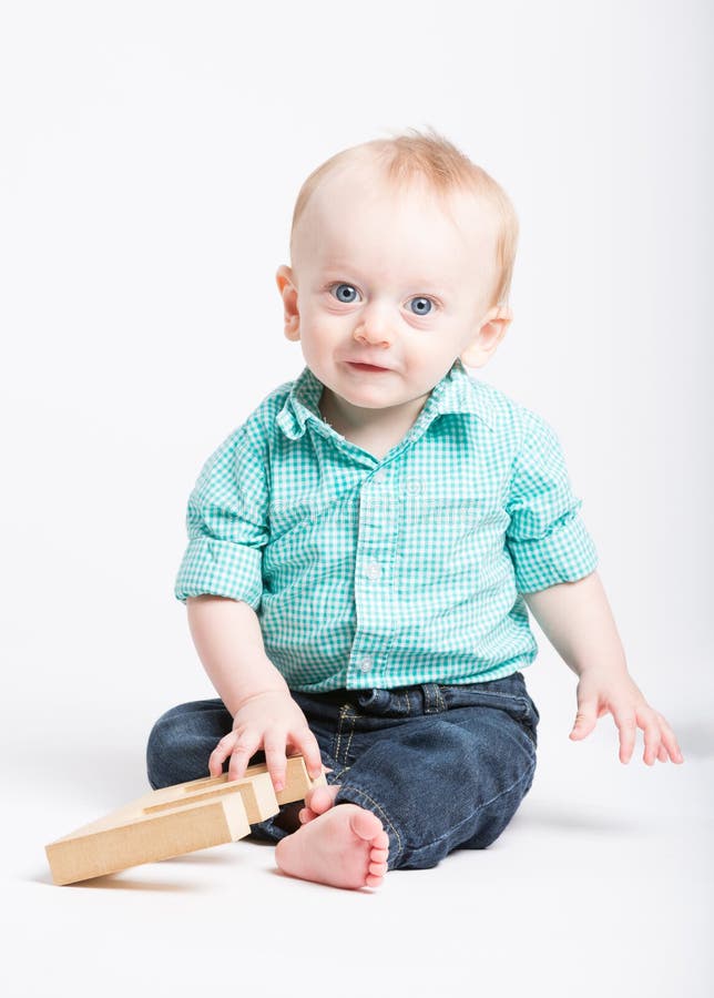 Baby Sitting Smiling at Camera Stock Image - Image of jeans, shirt ...