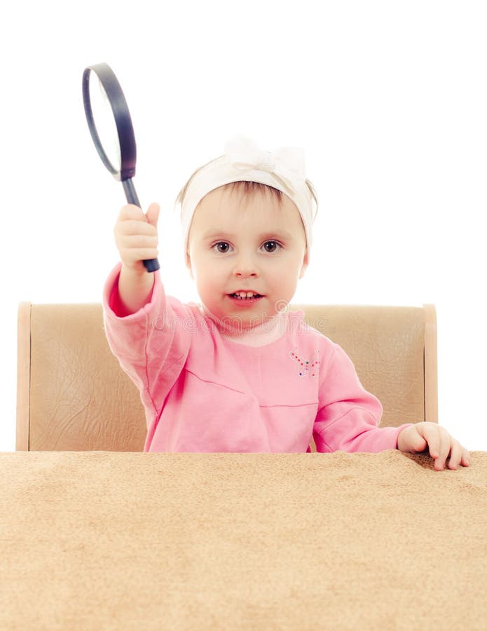 Baby Sitting at a Table with Magnifying Glass Stock Photo Image of