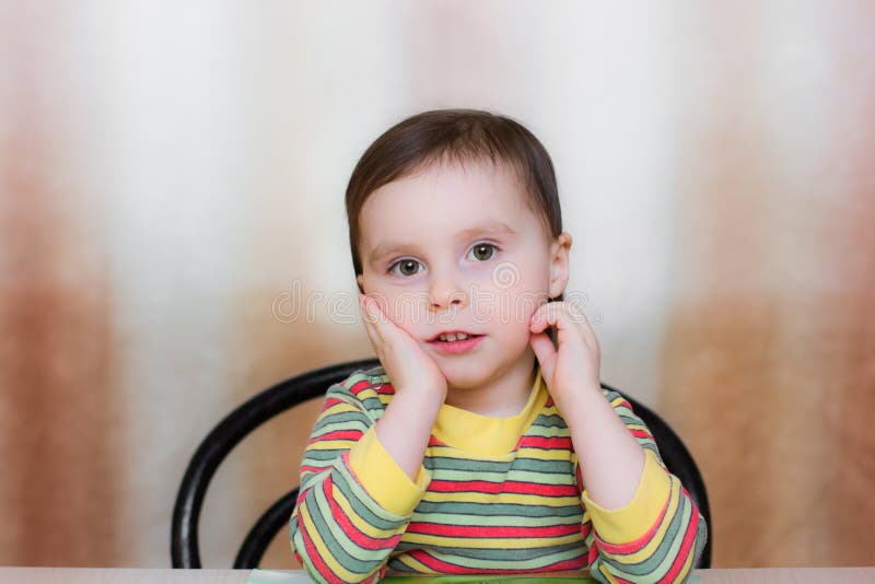 Baby sitting at a table stock image. Image of lens, hand 30508447