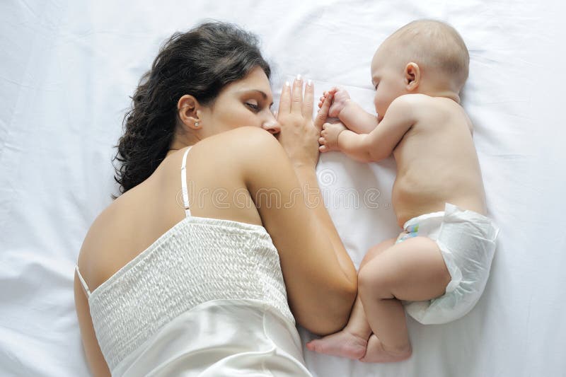 Baby sleeping close to her mother