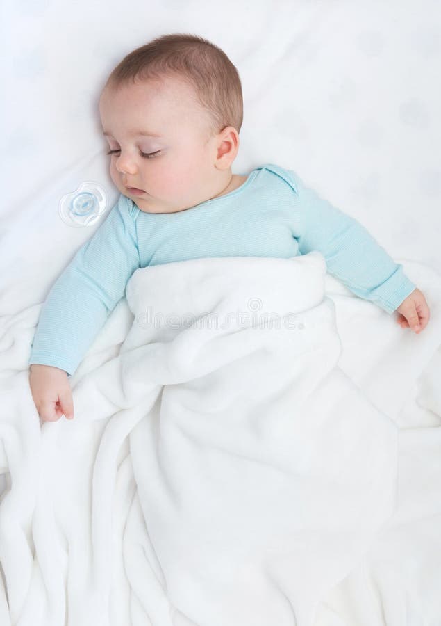 Baby Sleeping with a Pacifier Aside. Stock Photo Image of
