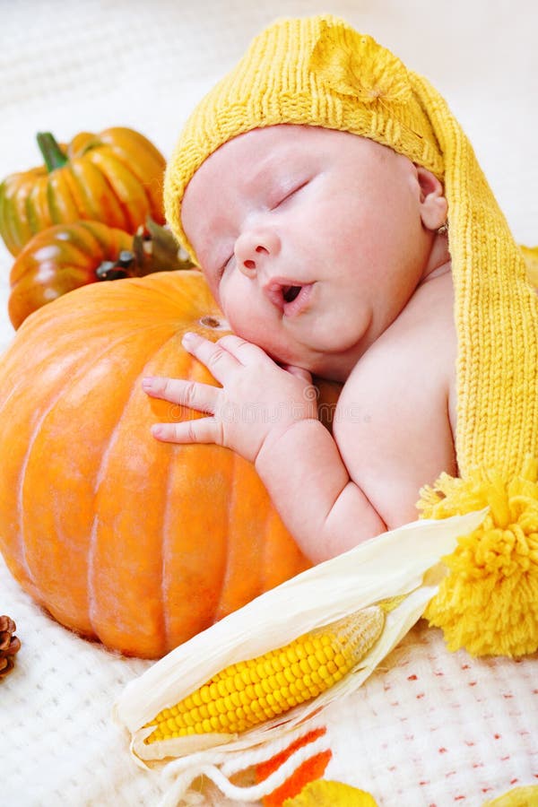 Baby sleeping on a pumpkin royalty free stock images Baby sleeping on a pumpkin royalty free stock images