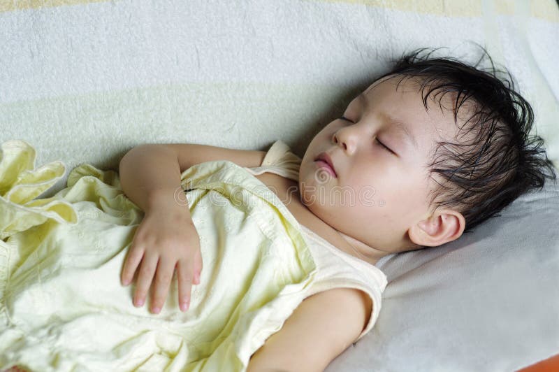 Baby sleeping in sofa stock photo. Image of lying, serene 20978012