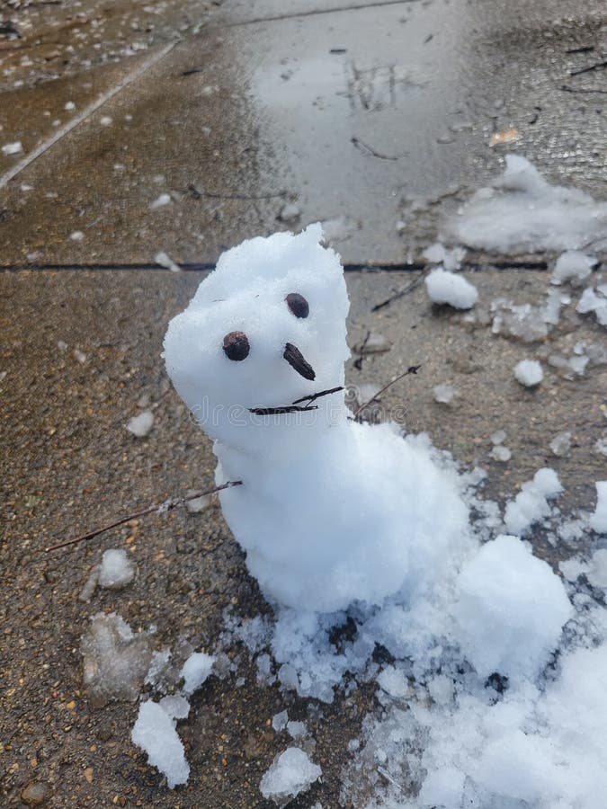 Baby snowman sitting on concrete royalty free stock photography