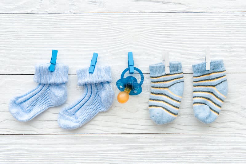 Baby socks on rope at wooden background. Top view royalty free stock photography Baby socks on rope at wooden background. Top view royalty free stock photography