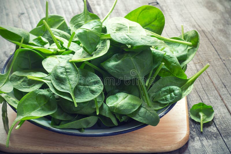 Baby Spinach. On wooden table stock image