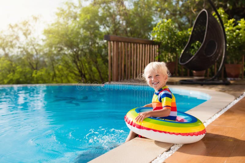 Baby in swimming pool. Kids swim. Child summer fun.