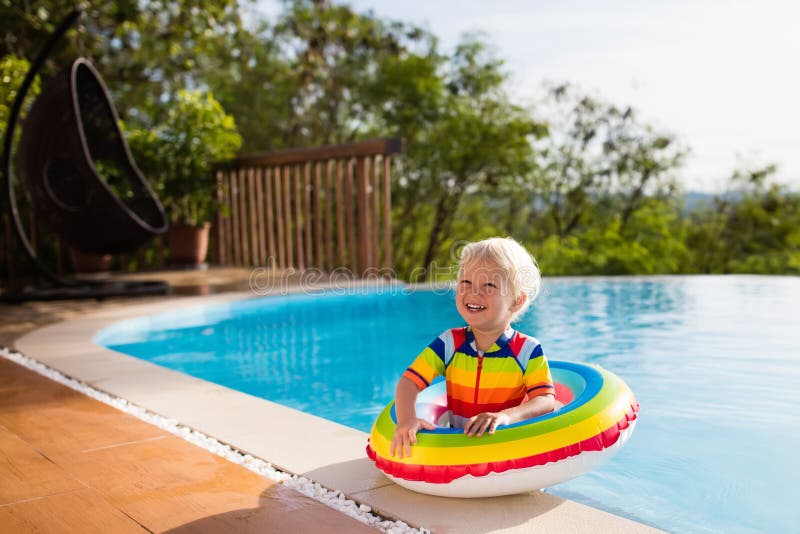 Baby in swimming pool. Kids swim. Child summer fun.