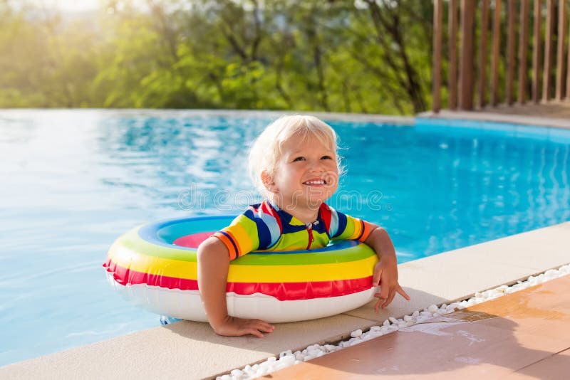 Baby in swimming pool. Kids swim. Child summer fun.