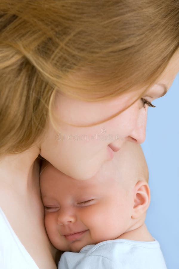 Baby of three months old in his mothers hands.