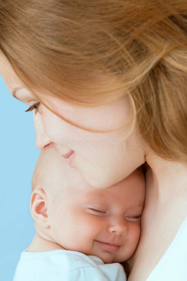 Baby of three months old in his mothers hands.