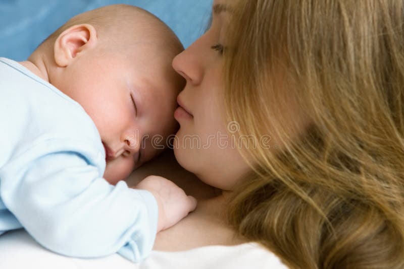 Baby of three months old in his mothers hands.