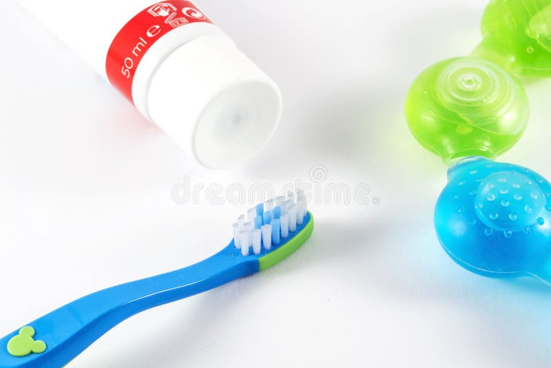 Closeup of Baby Toothbrushes and Toothpaste on Color Background Stock