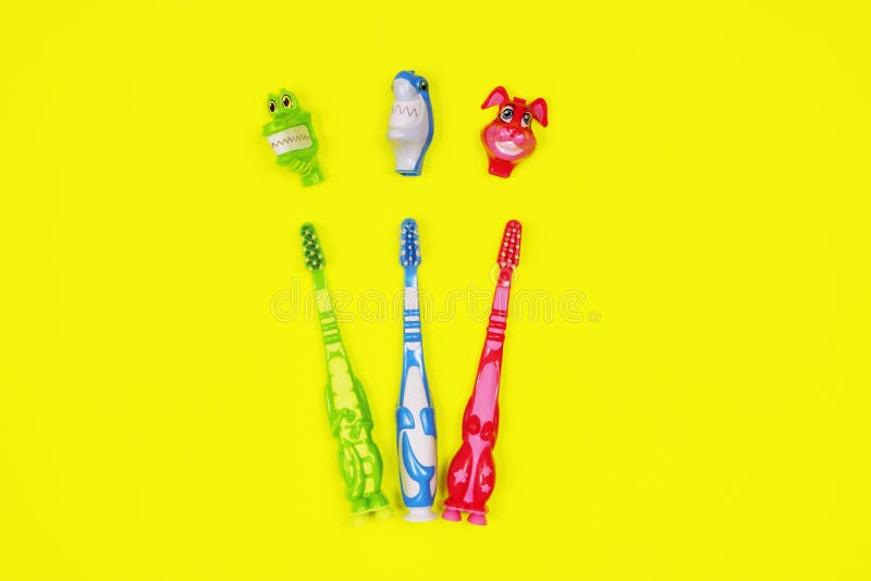 Baby toothbrushes on yellow background stock image