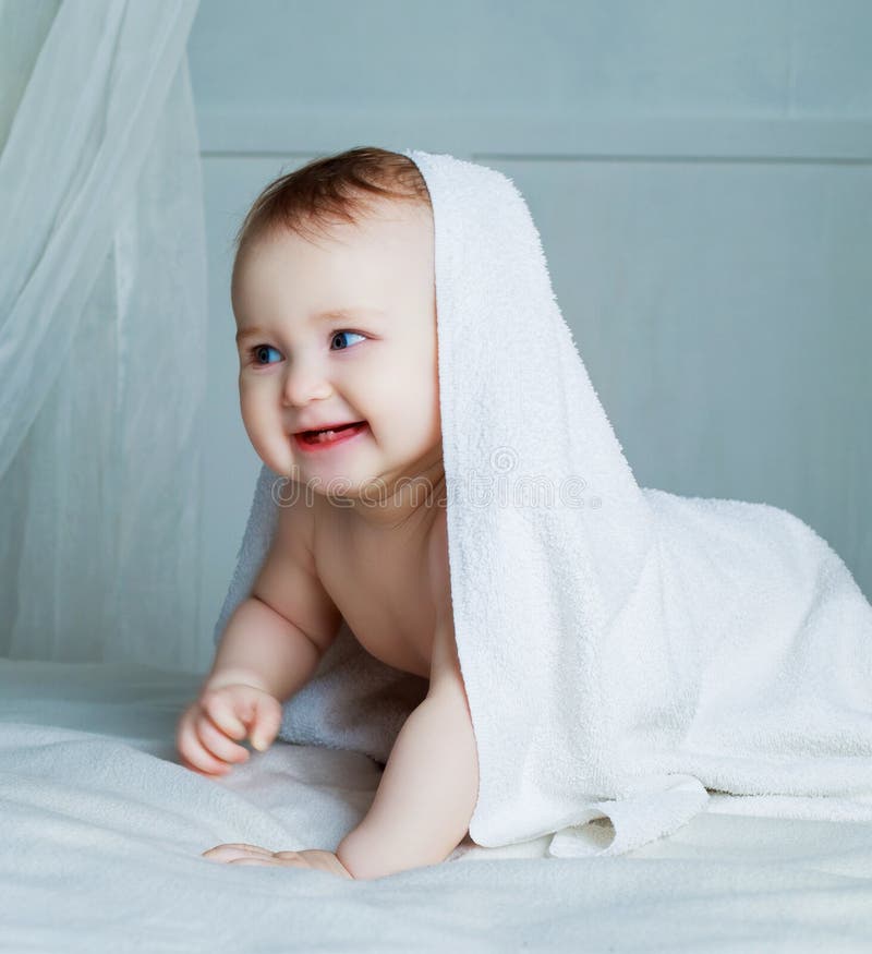 Baby with a towel stock image. Image of indoors, hygiene 77199301