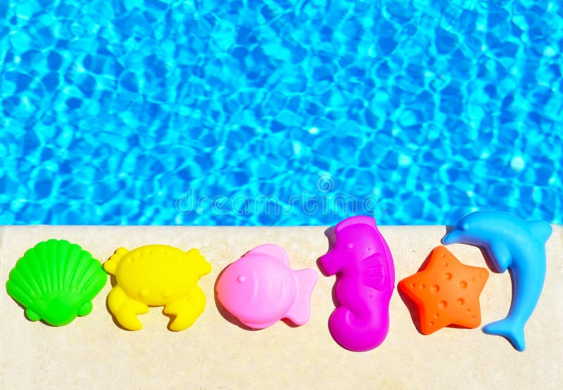 Baby Toys on the pool background. stock photography