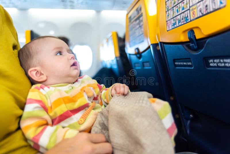 Baby traveling by plane stock photo. Image of passenger 168538362
