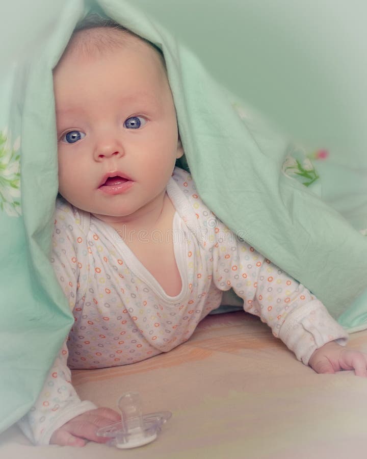 Baby Under Blanket With Big Blue Eyes Stock Photo Image of person