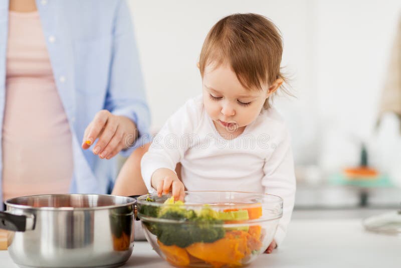 Baby with Vegetables and Mother Cooking at Home Stock Image - Image of ...