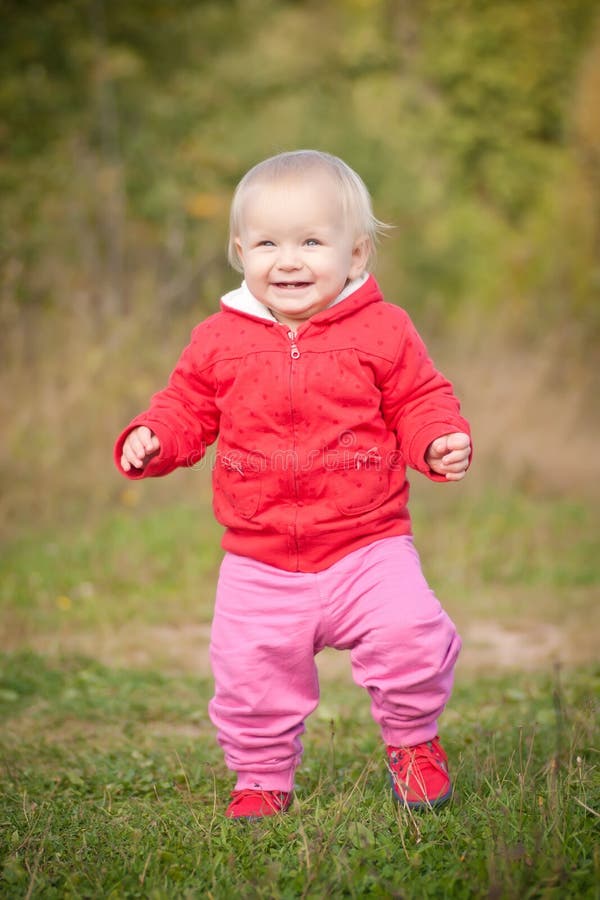 Baby walking by the road in field