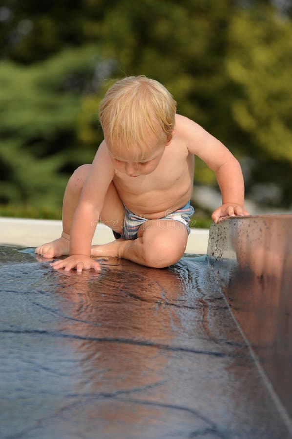 Baby on water slide stock photos