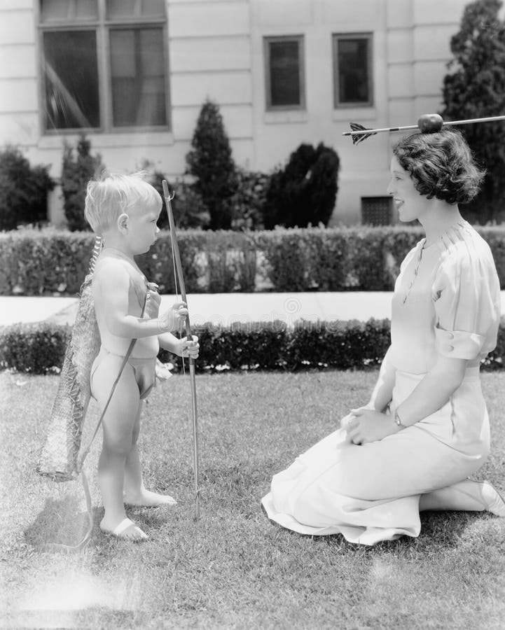 Babycupido die appel op het hoofd van de vrouw schieten (Alle afgeschilderde personen leven niet langer en geen landgoed bestaat stock foto's Babycupido die appel op het hoofd van de vrouw schieten (Alle afgeschilderde personen leven niet langer en geen landgoed bestaat stock foto's