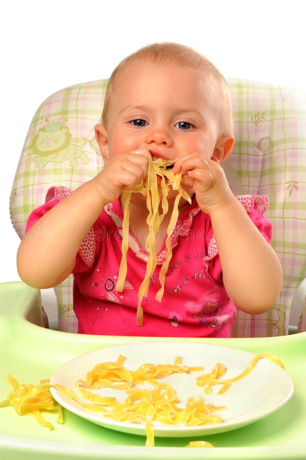 Babymeisje die deegwaren eten royalty-vrije stock foto Babymeisje die deegwaren eten royalty-vrije stock foto