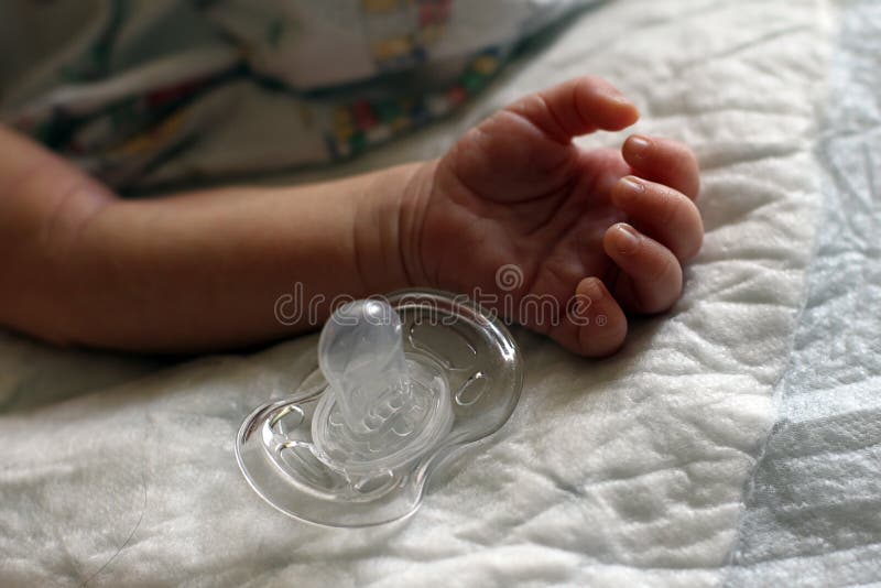 Babys hand and pacifier stock image. Image of small, handle 39972373