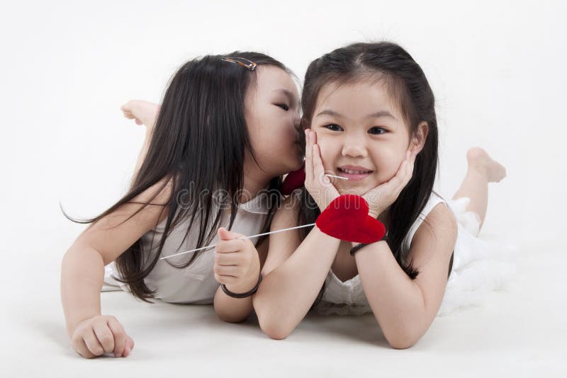 Little girl kissing her sister. Little girl kissing her sister