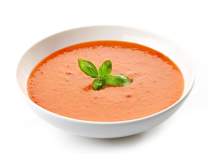 Bacia de sopa do tomate com manjericão fotografia de stock Bacia de sopa do tomate com manjericão fotografia de stock