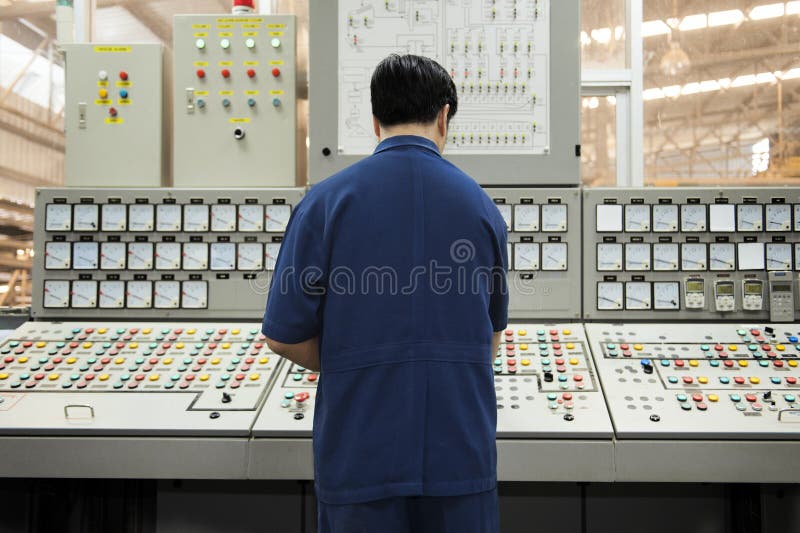 Back of Engineer in control room. royalty free stock photos