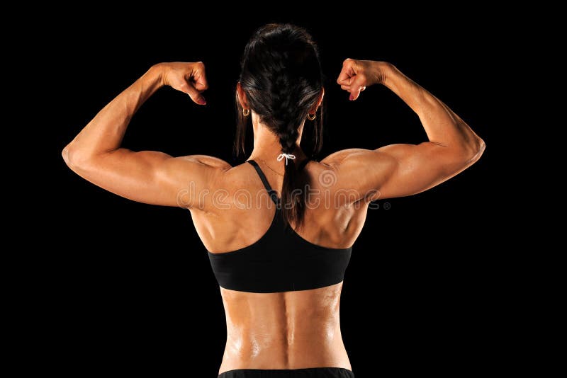 Muscular woman in gym showing back muscles. Strong fitness girl
