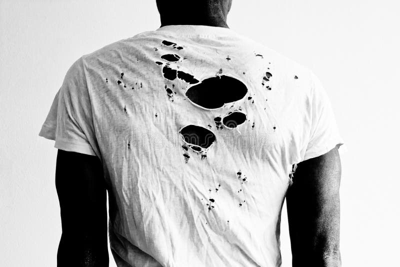 Back of a man wearing a torn white t-shirt