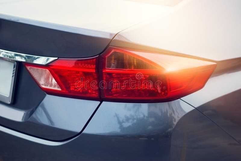 Back Light of Sport Car after the Rain on the Street Background Stock